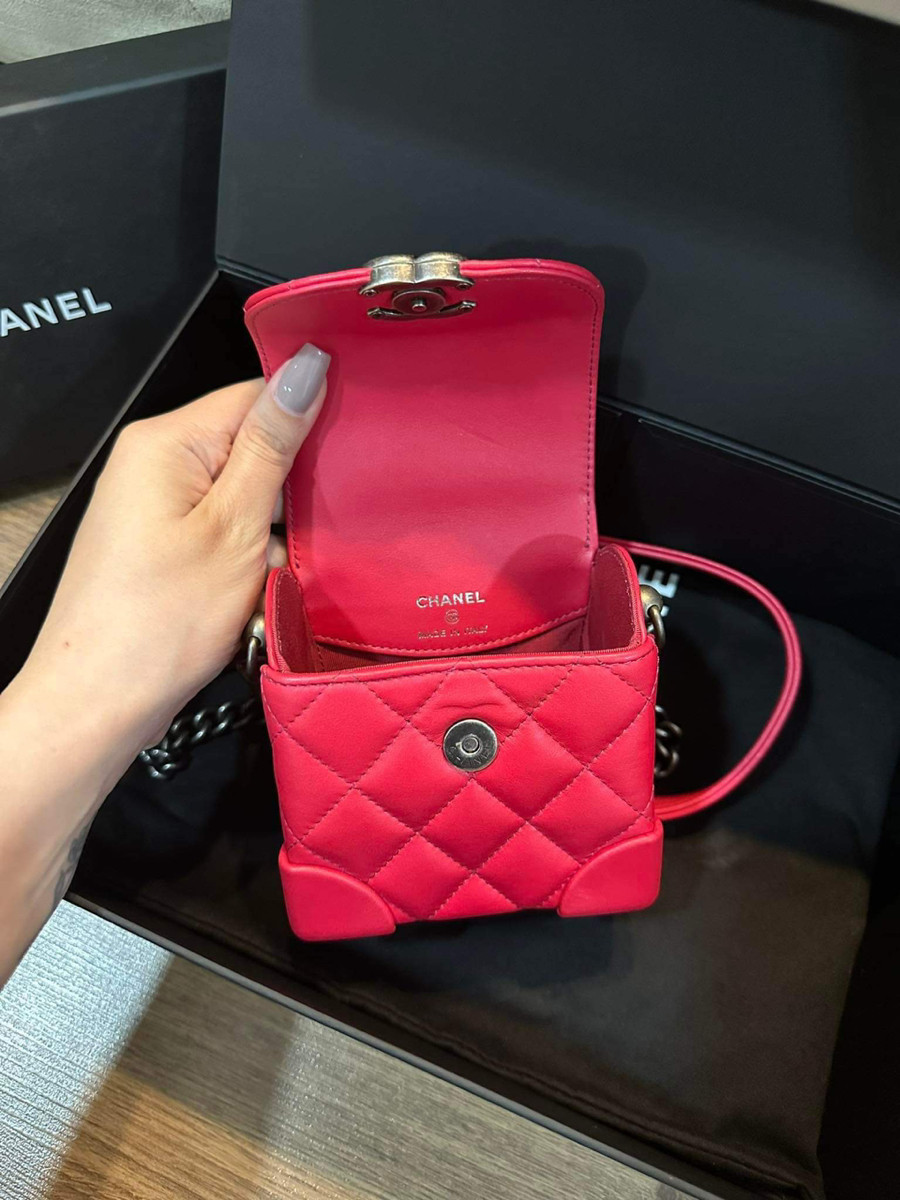 Chiếc túi Chanel màu đỏ hồng thiết kế điển hình của thương hiệu, logo  C nổi bật ở mặt trước, và dây xích màu ghi giả cổ.